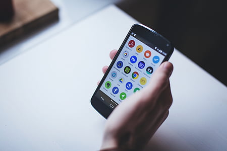 person holding turned-on black Android smartphone thumbnail