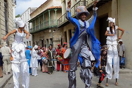 three persons walking with stilts thumbnail