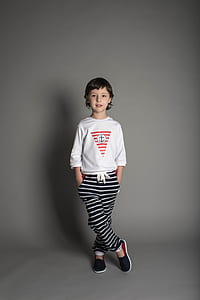 child standing against wall thumbnail