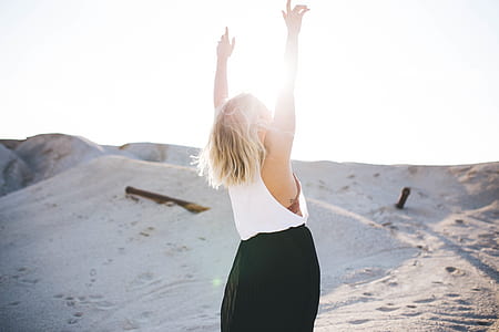 woman standing near sand hill thumbnail