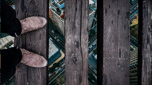 person standing on brown wooden plank thumbnail