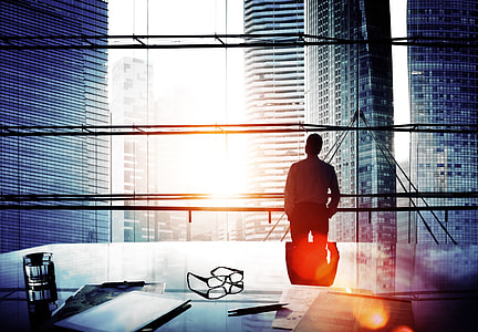 man standing beside glass window thumbnail