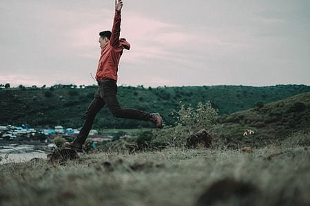 man jumping near cliff thumbnail