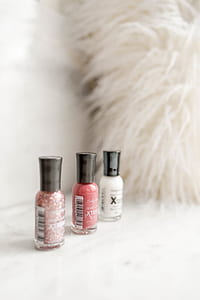 three assorted-color nail polish bottles thumbnail