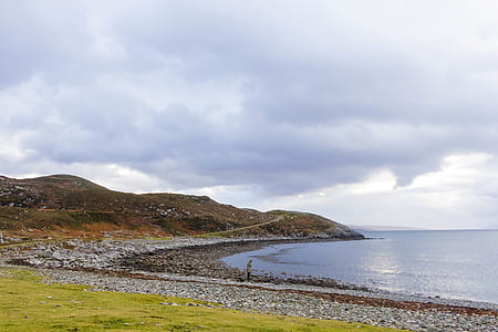 man standing on seashore thumbnail
