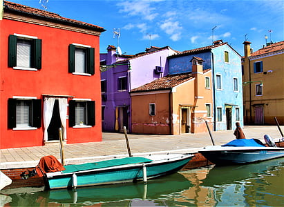 blue boats near houses thumbnail