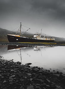 black ship near body of water thumbnail