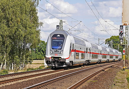 gray train near green leafed tree during daytime thumbnail