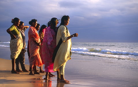 women standing near shoreline thumbnail