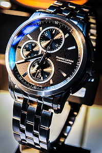 selective focus photography of round black chronograph watch with link band thumbnail
