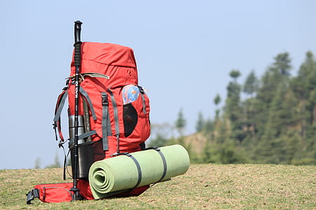 Selective Focus Photo of Red Hiking Backpack on Green Grass thumbnail