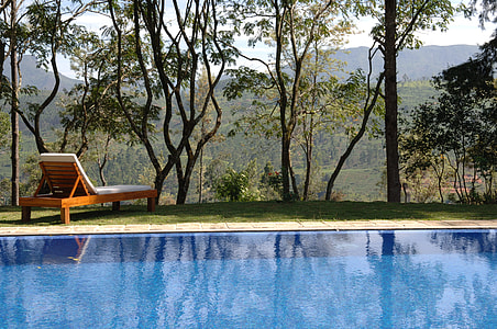 brown wooden lounge beside pool thumbnail