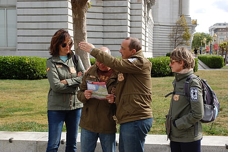 four person wearing jacket standing near tree thumbnail