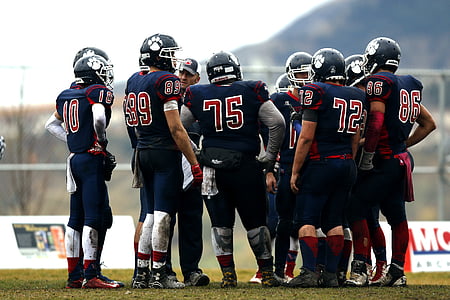 American football players on green field during daytime thumbnail