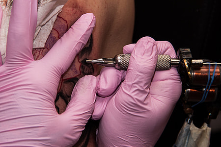 person tattooing on human skin thumbnail