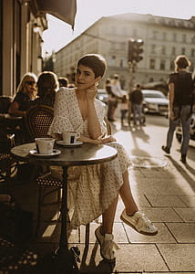 woman sitting on brown wooden chair thumbnail
