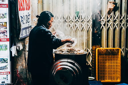 Photo of a Woman in Gray Long-sleeved Top Holding Plastic Bags thumbnail
