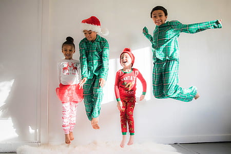 four children jumping on top of mattress thumbnail