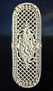 oval white metal person repousse decor thumbnail