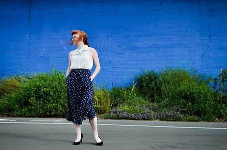 woman in white sleeveless top and blue midi skirt thumbnail