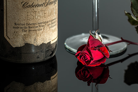 red rose near wine bottle photo thumbnail