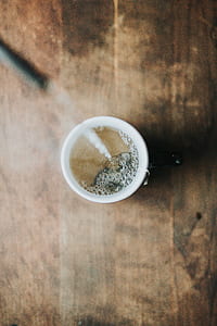 black ceramic mug with brown liquid inside thumbnail