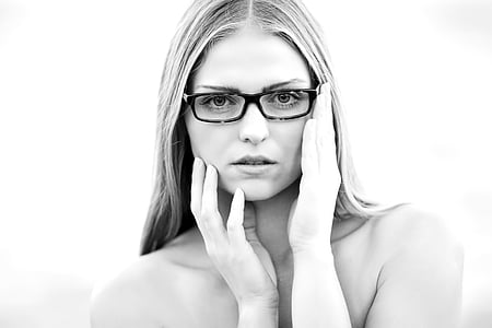 woman touching her face while wearing eyeglasses thumbnail