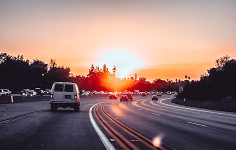 cars traveling at the city road during golden hour thumbnail