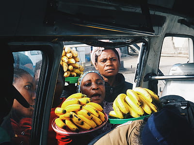 group of people holding ripe bananas thumbnail
