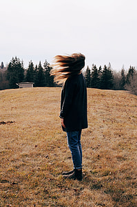 woman in black shirt standing on grass field during daytime thumbnail