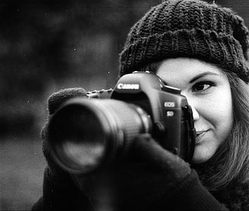 grayscale photo of woman using Canon EOS 5D thumbnail
