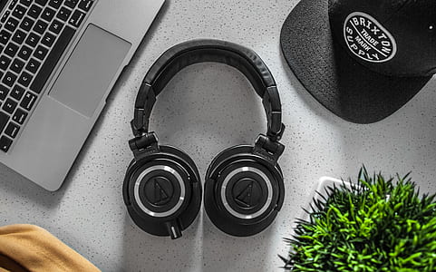 Black Wireless Headphones On White Table thumbnail