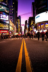 people walking on section road between buildings during nighttime thumbnail