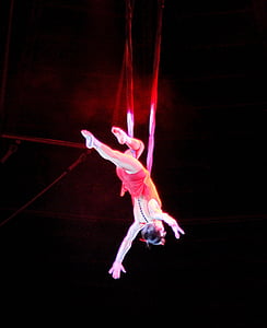 woman performing acrobatic stunts in dimmed room thumbnail