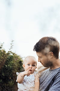 tilt-shift lens photography of man carrying girl thumbnail
