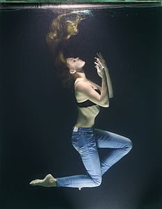 woman wears black brassiere and blue denim jeans underwater photo thumbnail