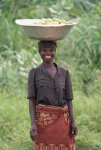 woman with stainless steel basin on her head filled with fruits thumbnail