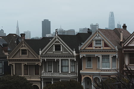 three brown concrete house on city thumbnail