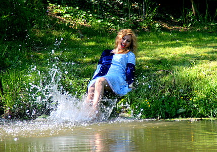 woman sitting on grass with water on feet thumbnail