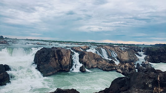 Landscape Photography of Rocks on Body of Water thumbnail