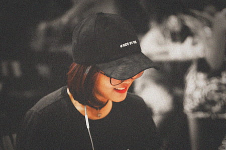 selective focus photography of woman wearing black baseball cap thumbnail