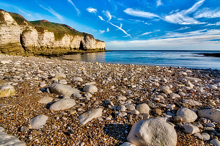 landscape photography of sea shore and mountain thumbnail