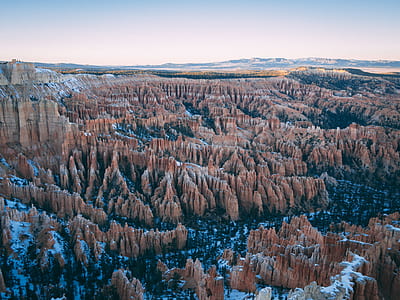 aerial view of rocky mountains under clear sky thumbnail