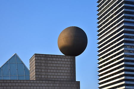 black ball on gray concrete building during daytime thumbnail