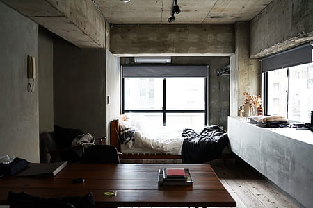 square brown wooden table beside bed frame near window thumbnail