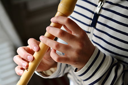person playing wooden flute thumbnail