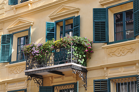 flowers on metal balcon railing thumbnail