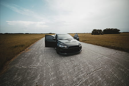 black Mitsubishi Lancer Evo on road thumbnail