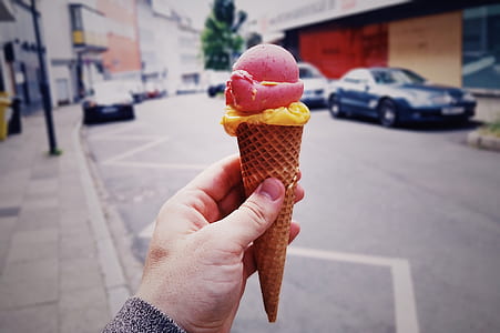 person showing ice cream on sugar cone thumbnail