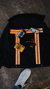 photo of three assorted-color cameras on backpack thumbnail